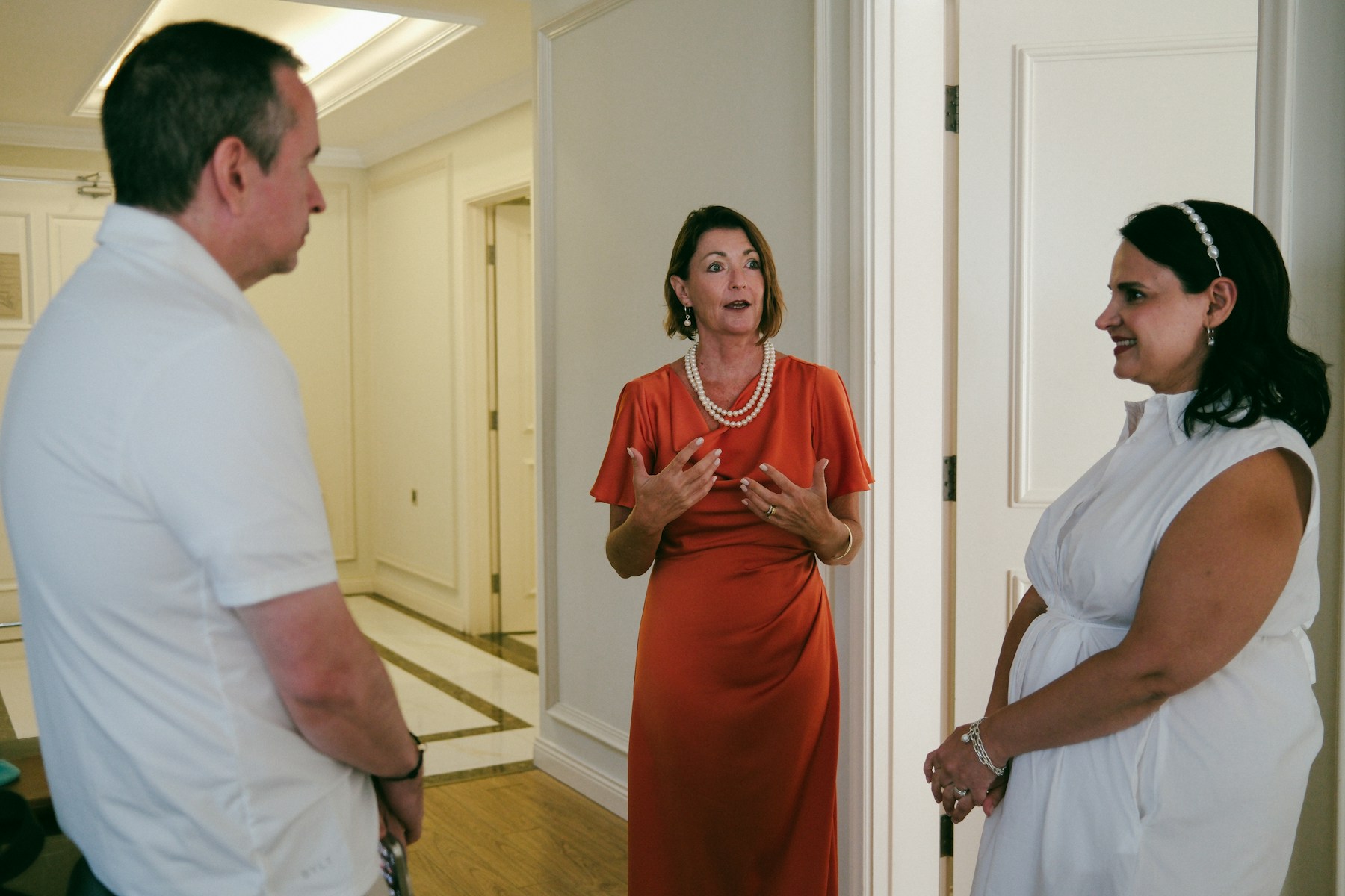 Conference attendees in conversation in a hallway